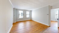 Located at 600 Georgia Ave in Chattanooga, TN, this one-bedroom, one-bathroom unit offers a thoughtfully arranged single-floor layout. The living room is a welcoming space highlighted by warm hardwood flooring, crisp crown molding, soft neutral-toned walls, and two windows that invite natural light to fill the room. The seamless flow connects the living area to the rest of the unit via a hallway that leads to the bedroom and kitchen.

The spacious bedroom is a standout feature, comfortably sized and bright with multiple windows on adjacent walls, allowing ample natural light and views of the surroundings. Hardwood floors continue throughout, and crown molding adds a refined touch. A dedicated closet with built-in hanging storage provides convenient organization.

The kitchen is clean and functional, equipped with white cabinetry, a double-basin stainless steel sink, white countertops, and a dishwasher, complemented by wood-look flooring. The bathroom features a clean, minimalist design with wood-look flooring, white walls, and a grab bar for added accessibility. A hallway with a closet rounds out the unit, adding practical storage. Overall, the space exudes a classic yet clean aesthetic well-suited for comfortable everyday living.