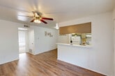 Located at 2424 Montgomery Road in Huntsville, Texas, this one-bedroom, one-bathroom unit offers a practical and well-organized single-floor layout. The open living area features warm wood-look flooring and a ceiling fan with light fixture, creating a comfortable, airy atmosphere. Natural light filters in through windows, brightening the clean white walls throughout.

The galley-style kitchen is efficiently designed, featuring cabinetry with upper storage, a stainless steel sink, dishwasher, full-size refrigerator, and a range with overhead ventilation. A pass-through counter connects the kitchen to the living area, enhancing the sense of openness and allowing for easy interaction between spaces.

A hallway connects the living area to the bedroom and bathroom. The bedroom is generously proportioned, finished with plush carpet and its own ceiling fan. A built-in closet with shelving provides ample storage. A second closet is also available elsewhere in the unit, adding further organizational convenience.

The bathroom is a standout feature, showcasing floor-to-ceiling marble-look tile surrounding a full soaking tub and shower combination, giving the space an elevated, spa-like feel. Overall, the unit offers a clean, functional, and comfortable living environment well-suited for individuals or couples seeking practical, move-in-ready accommodations in Huntsville, TX.