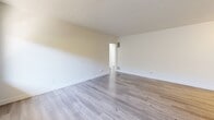 Located at 326-334 W Chevy Chase Dr in Glendale, CA, this 2-bedroom, 2-bathroom residence offers a clean, modern aesthetic across a well-organized single-floor layout. Light wood-style flooring runs throughout the unit, complementing the crisp white walls and textured ceilings to create a bright, cohesive atmosphere.

The living room is a comfortable, open space featuring a wall-mounted air conditioning unit and a large window that invites natural light and provides views of the surrounding neighborhood. A front entry door opens directly into this area, lending a welcoming feel.

The galley-style kitchen is efficiently designed with white shaker cabinetry, stone-look countertops, a gas range, and ample storage on both sides. A window at the end of the kitchen allows natural light to fill the space.

The primary bedroom is generously sized, featuring a ceiling fan with light fixture and a wide window showcasing scenic views of the Glendale cityscape and surrounding hills. The second bedroom is equally bright, with its own window offering open outdoor views.

Both bathrooms feature wood-style flooring, white vanities with stone-look countertops, and clean, simple finishes. One bathroom includes a full tub-shower combination with a window above for natural light. A connecting hallway ties all rooms together in a practical and functional flow.