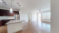 This contemporary 950 square foot apartment in Peridot Palms offers a harmonious blend of style and functionality. The open-concept layout seamlessly integrates the kitchen, living, and dining areas, creating an inviting space for both relaxation and entertainment. The kitchen stands out with its rich, dark wood cabinetry, contrasting beautifully with stainless steel appliances and a light-colored granite countertop. A central island provides additional prep space and casual seating.

Both bedrooms are generously sized, with the primary bedroom boasting 160 square feet of space. Large windows in each room flood the space with natural light and offer scenic views. The apartment features three well-appointed bathrooms, each showcasing modern fixtures and finishes. Warm wood-look flooring runs throughout, adding a touch of warmth to the sleek design.

A dedicated laundry area with full-sized washer and dryer adds convenience to daily living. The apartment also includes a private balcony, perfect for enjoying outdoor air or taking in the surroundings. With its thoughtful design and premium amenities, this Peridot Palms apartment offers a luxurious and comfortable living experience in a prime location.