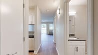 Located at 100 Tanglewood Ct in Nashville, TN, this efficiently designed single-floor unit makes smart use of its compact footprint. A central hallway connects all areas of the home, creating a logical and easy-to-navigate layout. The living room is bright and welcoming, featuring durable wood-style flooring, a ceiling fan with integrated light, a textured ceiling, and large windows with vertical blinds that allow for generous natural light. A wall-mounted HVAC unit ensures year-round comfort. The kitchen is thoughtfully equipped with white shaker-style cabinetry, a stainless steel refrigerator, an electric range, and a range hood. An adjacent pantry with open shelving provides excellent additional storage. The bathroom offers a full tub/shower combo finished with classic white subway tile, complemented by a white vanity with a sink and a well-lit mirror. Three closets throughout the unit offer abundant storage solutions. Consistent wood-style flooring runs through the main living areas, while textured walls and ceilings add a subtle architectural character. The overall aesthetic is clean, neutral, and move-in ready, providing a comfortable and practical living environment in a convenient Nashville location.