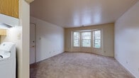 Located at 4218 Hickory Rd in Mishawaka, Indiana, this single-floor unit presents a practical and well-organized layout suited for comfortable everyday living. The living area serves as the focal point of the space, highlighted by a curved bay window arrangement that draws in generous natural light and offers views of the surrounding neighborhood. Neutral-toned carpet flows throughout, complementing the clean, light-colored walls and textured ceiling that give the room an open, airy feel.

The bedroom areas are carpeted and offer a calm, understated atmosphere. One bedroom features access to an adjacent hallway with a set of louvered bifold closet doors, providing substantial storage capacity. A second room with a window fitted with horizontal blinds adds further flexibility for use as a bedroom or additional living space.

The bathroom is finished with tile flooring in earthy tones, a tiled tub-and-shower surround, and a vanity with a light countertop, maintaining a clean and functional aesthetic throughout. The 3D layout scan indicates a kitchen area with standard appliances and adjacent spaces that support an efficient, connected flow between rooms.

Overall, this single-level space offers a straightforward design with consistent finishes, natural light, and practical storage throughout.