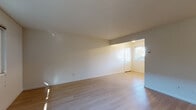 Located at 1401 Liberty St in El Cerrito, California, this single-floor unit offers a clean, functional layout with a bright and welcoming atmosphere throughout. The spacious living area is finished with light-toned hardwood-style flooring that reflects natural light streaming in through large windows, creating an open and airy feel. A dedicated entryway with a classic paneled front door provides a pleasant sense of arrival.

The kitchen is efficiently designed in a galley-style configuration, featuring granite-look countertops, white cabinetry with ample storage above and below, a stainless sink, and white appliances including a range and refrigerator. A window with blinds allows natural light into the cooking space.

The bedrooms are carpeted in a neutral tone, providing warmth and comfort underfoot. Each bedroom benefits from windows that invite natural light and views of the surrounding neighborhood, including glimpses of mature trees and the quiet residential streetscape.

The bathroom is well-appointed with a single-sink vanity featuring a light countertop, a full-size tub and shower combination enclosed by sliding frosted glass doors, and wood-style flooring. The clean white finishes throughout the bathroom contribute to a bright, functional space.

Overall, the unit presents a straightforward, move-in-ready layout suited to everyday living in a pleasant El Cerrito neighborhood setting.