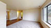 Located at 430 Eastern St in New Haven, Connecticut, this single-floor unit offers a practical and well-organized layout designed for comfortable everyday living. The open living area features plush carpeting that transitions seamlessly into the kitchen, which is finished with durable hardwood-style flooring. The kitchen is equipped with warm wood-toned cabinetry, a full-size refrigerator, a white electric range, and ample counter space, making it both functional and efficient. A bifold-door closet adjacent to the kitchen provides convenient additional storage. The spacious living and dining area opens toward the bedroom hallway, creating a natural flow throughout the unit. The bedrooms are carpeted and well-lit, each featuring windows that bring in natural light and views of the surrounding neighborhood. One bedroom includes a mirrored sliding-door closet, offering generous storage space. The unit includes two bathrooms: a full bath with a soaking tub, shower combination, wood-toned vanity, and large mirror, as well as a second bathroom with a single vanity and hardwood-style flooring. Textured ceilings are found throughout, and neutral wall tones provide a clean, versatile backdrop. The thoughtful floor plan maximizes usability across every room of this single-level home.