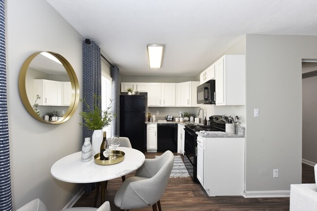 Kitchen with granite counters and black appliances - Reserve at Lindsay