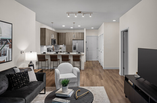 Open Floorplan View of Living Room and Kitchen - Serenza at Ocoee Village Apartments