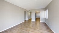 Located in Tampa, FL, this single-floor, 2-bedroom, 2-bathroom unit offers a functional and well-appointed layout across a comfortable footprint. The living room is bright and open, featuring light wood-style flooring and a sliding glass door with vertical blinds that opens onto a private patio, allowing natural light to flow in while providing pleasant outdoor views. The galley-style kitchen is efficiently designed with white shaker cabinetry on both sides, granite-look countertops, a tiled backsplash, a stainless steel sink, and black appliances including a range and refrigerator. The layout connects the kitchen directly to the living area, supporting an easy flow throughout the unit. Both bedrooms are comfortably sized with neutral gray walls and wood-style flooring. The primary bedroom includes a large sliding double closet, while the second bedroom features a window that brings in natural light. Each bedroom is served by its own bathroom. One bathroom includes a full tub-shower combination with white tile surround and a white vanity, while the second bathroom features a standalone shower and matching white finishes. Hallways connect the rooms efficiently, and two dedicated closets provide additional storage. The textured ceilings and clean, neutral palette throughout give the space a cohesive and move-in-ready appearance.