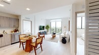 Located at 1601 Southwest 32nd Avenue in Miami, FL, this thoughtfully designed three-bedroom, two-bathroom residence offers a bright and contemporary living experience across a single floor. The open-concept living and kitchen area serves as the heart of the home, featuring light wood-tone flooring that flows seamlessly throughout the space. Large floor-to-ceiling windows and sliding glass doors flood the living room with natural light while providing direct balcony access and sweeping views of the lush Miami treetops and city skyline beyond.

The kitchen is outfitted with full-height light wood cabinetry, stainless steel appliances including a French-door refrigerator, electric range, microwave, and dishwasher, along with ample counter space and recessed lighting overhead.

The primary bedroom is a comfortable retreat featuring a large window with scenic views, built-in closet, and light-filled ambiance. Additional bedrooms offer generous built-in storage and access to natural light. Two well-appointed bathrooms include vanities with wood-toned cabinetry, mirrors, and shower-tub combinations. Throughout the unit, crisp white walls, light flooring, and modern finishes create a clean, airy aesthetic reflective of contemporary Miami living.