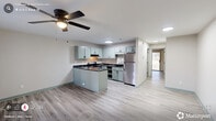 Located at 616 E Knox St in Durham, NC, this well-appointed one-bedroom, one-bathroom residence offers a thoughtfully designed single-floor layout. Light gray luxury vinyl plank flooring runs throughout, creating a cohesive and easy-to-maintain foundation across all rooms.

The open-concept living, dining, and kitchen area forms the heart of the home. The kitchen is outfitted with sage-green cabinetry, dark granite countertops, stainless steel appliances including a range and refrigerator, and a peninsula that provides additional prep space and a natural division between the kitchen and living areas. Ceiling fans with integrated lighting are present in both the living area and the bedroom, promoting comfort and airflow.

The living space features a front-facing window that brings in natural light, along with a charming sage-green six-panel entry door that adds a pop of color. The bedroom is a comfortable, well-sized retreat with a ceiling fan and sliding glass doors that open directly to a private outdoor deck, offering pleasant outdoor views and easy access to fresh air.

The bathroom includes a full tub-shower combination, a toilet, and a vanity with matching sage-green cabinetry. Additional conveniences include two closets and a dedicated laundry area, making this a fully functional and efficiently organized home.