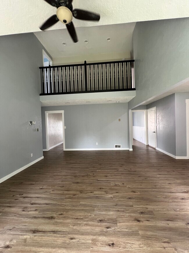 main floor living room with view of upstairs balcony - 2965 Bluebird Ln