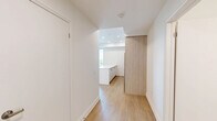 Located at 150 Wissler Rd in Waterloo, Ontario, this well-appointed 2-bedroom, 2-bathroom unit offers a clean, modern aesthetic across a thoughtfully designed single-level floor plan. Light-toned hardwood flooring runs throughout the living areas and bedrooms, lending warmth and continuity to the space.

The primary bedroom is generously sized, featuring a large window that frames pleasant views of the surrounding greenery, filling the room with natural light. The second bedroom also benefits from the same attractive flooring and includes a sliding closet, making efficient use of space.

Both bathrooms are finished with crisp white subway tile. The main bathroom features a full soaker tub with an overhead shower, while the second bathroom offers a sleek glass-enclosed walk-in shower with a multi-function showerhead — both reflecting a consistently modern design sensibility.

The kitchen is efficiently laid out and connects to the living area, supporting an open, functional flow. A dedicated hallway with an additional closet provides practical storage and connects the various rooms seamlessly.

The overall ambiance of the unit is bright, clean, and contemporary, with a neutral palette throughout that creates a calm and versatile living environment well-suited to a variety of lifestyles.