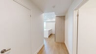 Located at 150 Wissler Rd in Waterloo, Ontario, this well-appointed 2-bedroom, 2-bathroom unit offers a clean, modern aesthetic across a thoughtfully designed single-level floor plan. Light-toned hardwood flooring runs throughout the living areas and bedrooms, lending warmth and continuity to the space.

The primary bedroom is generously sized, featuring a large window that frames pleasant views of the surrounding greenery, filling the room with natural light. The second bedroom also benefits from the same attractive flooring and includes a sliding closet, making efficient use of space.

Both bathrooms are finished with crisp white subway tile. The main bathroom features a full soaker tub with an overhead shower, while the second bathroom offers a sleek glass-enclosed walk-in shower with a multi-function showerhead — both reflecting a consistently modern design sensibility.

The kitchen is efficiently laid out and connects to the living area, supporting an open, functional flow. A dedicated hallway with an additional closet provides practical storage and connects the various rooms seamlessly.

The overall ambiance of the unit is bright, clean, and contemporary, with a neutral palette throughout that creates a calm and versatile living environment well-suited to a variety of lifestyles.