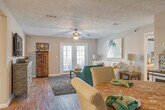 Located at 350 Byram Drive in Byram, Mississippi, this well-appointed single-story home offers a thoughtfully designed layout with comfortable living spaces throughout. The living room serves as an inviting centerpiece, featuring rich hardwood-style flooring, a ceiling fan with light fixture, a textured ceiling, and French doors that fill the space with natural light. The kitchen is outfitted with crisp white cabinetry, granite-style countertops, a classic subway tile backsplash, a double-basin sink, and black appliances including a range and built-in microwave. Hardwood-style flooring continues throughout the kitchen, complementing the clean, functional design. The home includes multiple bedrooms, each carpeted for comfort and equipped with ceiling fans and windows that bring in ample natural light. The primary bedroom benefits from its own en-suite bathroom and a generously sized walk-in closet with built-in wire shelving on multiple walls. The bathrooms feature white vanities with granite-style countertops, hardwood-style flooring, and tub-shower combinations. A dedicated laundry room accommodates a full-size washer and dryer side by side. The home's neutral color palette and cohesive finishes create a warm, welcoming atmosphere throughout.