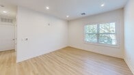Located at 175 Rock Rd in Bergen, NJ, Unit 1302 is a thoughtfully designed one-bedroom, one-bathroom residence that maximizes its well-proportioned floor plan with a clean, modern aesthetic throughout. Light hardwood flooring flows seamlessly across the entire unit, lending warmth and continuity to every room.

The open-concept kitchen and living area forms the heart of the home. The kitchen is outfitted with natural wood cabinetry, a subtle tile backsplash, stainless steel appliances including a gas range, built-in microwave, and French door refrigerator, as well as a striking quartz waterfall island that doubles as a dining and prep space. Recessed lighting illuminates the area, while a large window in the adjoining living space invites abundant natural light and views of surrounding greenery.

The bedroom offers a comfortable and serene retreat, featuring a generously sized closet with sliding panel doors and a window overlooking lush outdoor scenery. Additional rooms throughout maintain the same bright, neutral palette with crisp white walls and recessed lighting.

The bathroom is a standout feature, showcasing a full walk-in shower enclosed by frameless sliding glass doors and clad in large-format marble-look tile with built-in corner shelving — a refined, spa-like finish that elevates the overall feel of the unit.
