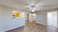 Located at 300 Chapel Ridge Dr in Cabot, Arkansas, this single-story, 3-bedroom, 2-bathroom home offers a practical and comfortable layout. The living room features light wood-look flooring, a ceiling fan, and a large window that fills the space with natural light. It connects seamlessly to the combined kitchen and dining area, where warm honey-toned cabinetry lines a galley-style kitchen equipped with a white electric range, dishwasher, refrigerator, and stainless steel microwave, all set over durable light-toned flooring. The primary bedroom is a generously sized retreat with plush carpeting, a ceiling fan, and a dedicated walk-in closet. The primary bathroom features a dual-sink vanity with oak cabinetry, a wide mirror, light flooring, and ample counter space. Two additional bedrooms also feature carpet flooring, ceiling fans, and individual closets, offering versatile space for guests or a home office. A dedicated laundry area accommodates full-sized appliances with added overhead shelving. A central hallway connects all rooms efficiently. Textured ceilings and neutral-toned walls throughout give the home a clean, move-in-ready appearance.