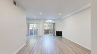 This thoughtfully designed 2-bedroom, 2-bathroom residence offers a comfortable and functional single-floor layout. The bright and open living room serves as the heart of the home, featuring light wood-look flooring throughout, recessed lighting, and a classic fireplace. Two sets of sliding glass doors — one framed by a distinctive arched transom window — invite an abundance of natural light and provide direct access to an outdoor balcony with views of surrounding greenery.

The kitchen is well-equipped with crisp white shaker-style cabinetry, gray countertops, stainless steel appliances including a gas range and dishwasher, and a striking blue subway tile backsplash that adds a pop of character.

The spacious primary bedroom includes a dedicated walk-in closet with built-in shelving and an en-suite bathroom, which features a tub/shower combo, toilet, and vanity with mirror. The second bedroom offers a clean, open layout with the same wood-look flooring. A second full bathroom serves additional guests or residents. Consistent light tones and neutral finishes throughout create a cohesive, modern aesthetic that is both inviting and easy to personalize.