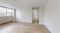 Located on the 7th floor at 1231 Richmond St in London, Ontario, this well-appointed 2-bedroom unit offers a thoughtfully designed single-floor layout with generous overall living space. Light-toned luxury vinyl plank flooring flows consistently throughout, lending a clean, cohesive aesthetic to every room.

The modern kitchen is a standout feature, showcasing light wood cabinetry, a grey tile backsplash, stainless steel appliances including a range, microwave, dishwasher, and refrigerator, as well as a large central island with a quartz-style countertop — ideal for both meal preparation and casual dining. The kitchen opens seamlessly into the dining and living areas, creating an airy, open-concept feel. The living room is bright and spacious, with large windows that invite natural light and offer views of the surrounding neighbourhood.

Both bedrooms are well-sized, each featuring sliding or hinged closet doors and access to the hallway. The primary bedroom provides a comfortable retreat with its own dedicated closet space. With seven closets distributed throughout the unit, storage is abundant. A private balcony extends the living space outdoors. The entrance and hallway provide a welcoming transition into the home's open layout. Neutral wall tones and clean finishes throughout give the unit a fresh, move-in-ready character.