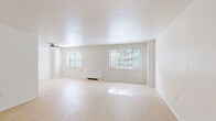 Located at 8040 Rowland Ave in Philadelphia's 19136 zip code, this one-bedroom, one-bathroom unit delivers a well-organized single-floor layout designed for comfortable everyday living. Light-toned hardwood-style flooring flows throughout the main living areas, while large windows invite an abundance of natural light across the spacious living room, which also features a ceiling fan. A separate dining area connects naturally to the kitchen, which is outfitted with white cabinetry, quartz-style countertops, a stainless steel refrigerator, and a sink — offering a clean, modern aesthetic. The generously sized bedroom is carpeted for comfort and includes a window with outdoor views and its own heating unit. A hallway connects the rooms efficiently, and a stacked washer and dryer unit is conveniently integrated near the entryway, adding in-unit laundry functionality. The bathroom features a soaking tub surrounded by elegant subway tile in a soft neutral tone, lending a clean and classic finish. Crisp white walls throughout the unit create a bright, neutral canvas. This well-appointed single-floor residence combines practicality with a clean, modern design in a convenient Philadelphia location.