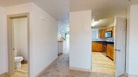 Located at 355 Country Ridge Dr in Red Lion, PA, this three-bedroom, three-bathroom home is thoughtfully laid out across three floors. The entry-level garage features a concrete floor and an automatic opener, providing convenient covered parking and additional storage space. The main living floor hosts a combined kitchen and living area, where warm honey-toned cabinetry, dark countertops, stainless steel appliances, and light hardwood-style flooring give the kitchen a functional, welcoming character. The adjacent living room features plush carpeting, a staircase with wood-trimmed railings, and a sliding glass door that fills the space with natural light. The separate dining room is accented by a classic chandelier and a large window overlooking the neighborhood's greenery. Each of the three bedrooms is carpeted and well-proportioned, with the spacious primary bedroom offering its own dedicated closet. The three bathrooms are clean and practical, featuring wood-toned vanity cabinetry, white countertops, and light hardwood-style flooring. A utility room and multiple closets throughout add valuable storage. With neutral finishes, textured ceilings, and a well-organized floor plan, this home offers a comfortable and functional living environment.