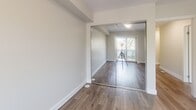 Located at Prospect Street in Burlington, Ontario, this well-appointed 1-bedroom, 2-bathroom two-storey unit offers a thoughtfully designed layout spread across two levels. The main floor welcomes you with an open-concept kitchen and living area, where light hardwood flooring flows throughout and large windows and sliding glass doors flood the space with natural light. The kitchen is a standout feature, showcasing white cabinetry, a subway tile backsplash, stainless steel appliances including a built-in microwave and refrigerator, dark countertops, and a central island with pendant lighting — ideal for both cooking and casual dining. The adjacent living area opens directly onto a private balcony, offering pleasant tree-lined views. A second bathroom on this level includes a stacked Whirlpool washer and dryer, providing convenient in-suite laundry. Upstairs, the primary bedroom is a calm, light-filled retreat with hardwood floors, a wide window overlooking the greenery, and a closet with full mirrored sliding doors. A well-finished full bathroom features classic white subway tile, a soaker tub with shower, and a quartz vanity. A dedicated closet and hallway complete the upper level. Two staircases and two balconies add to the functional and airy character of this modern home.