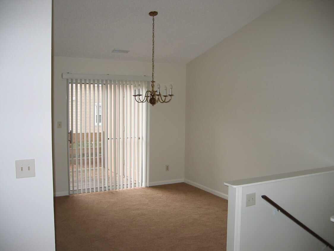 Entry to second floor into Dining Room with access to large deck. Notice cathedral ceiling. - 8937 Cardinal Ter