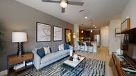 Located at 1630 Peachtree Industrial Blvd in Suwanee, GA, this thoughtfully designed one-bedroom, one-bathroom residence offers a contemporary open-concept layout with upscale finishes throughout. Light wood-style flooring flows seamlessly across the main living areas, complementing the neutral color palette and modern aesthetic.

The kitchen is a standout feature, equipped with stainless steel appliances including a refrigerator, electric range, microwave, and dishwasher. Rich dark wood cabinetry pairs elegantly with granite countertops and a classic white subway tile backsplash. A peninsula with bar seating and pendant lighting above creates a natural transition into the open living area.

The living room is bright and welcoming, with a large window inviting natural light and views of the surrounding greenery. A ceiling fan adds comfort, while the open sightlines to the kitchen enhance the sense of space.

The bedroom offers a serene retreat, featuring a window with outdoor views, a bold accent wall, and rustic floating shelves above the bed. The bathroom is well-appointed with a granite-topped dark wood vanity, a glass-enclosed walk-in shower with tile surround, and direct access to a walk-in closet with built-in shelving and rod storage.

This residence combines modern convenience with a warm, inviting ambiance.