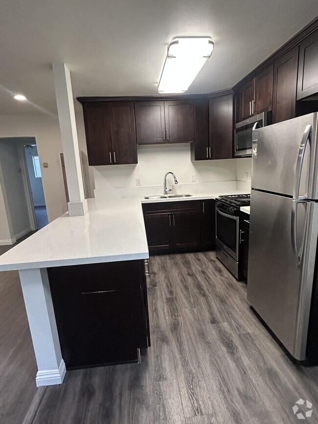 Fully remodeled gourmet kitchen with stainless steel appliances and quartz countertops - 278 E Washington Blvd