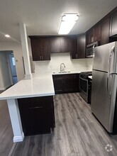 Fully remodeled gourmet kitchen with stainless steel appliances and quartz countertops - 278 E Washington Blvd