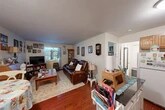 Located at 20 Scotch Grove Rd in Pulaski, NY, this single-floor, one-bedroom, one-bathroom home offers a compact and efficient layout designed to maximize every square foot. The living room serves as the heart of the home, featuring rich hardwood flooring, neutral walls, and a window dressed with decorative curtains that allow natural light to filter in. The space comfortably accommodates a seating area and an entertainment setup, creating a warm and inviting atmosphere. Adjacent to the living room, the kitchen is well-appointed with warm-toned oak cabinetry, dark countertops, and white appliances including a refrigerator, electric range, and built-in microwave. A peninsula island provides additional counter space and adds to the kitchen's functional character. The bedroom offers a cozy retreat with hardwood floors, a window providing natural light, and enough space for a full-sized bed and storage furniture. Three closets distributed throughout the home provide ample storage. The bathroom rounds out this efficiently arranged floor plan. With its practical layout and functional features, this home is well-suited for those seeking straightforward, easy-to-maintain living in the Pulaski, NY area.