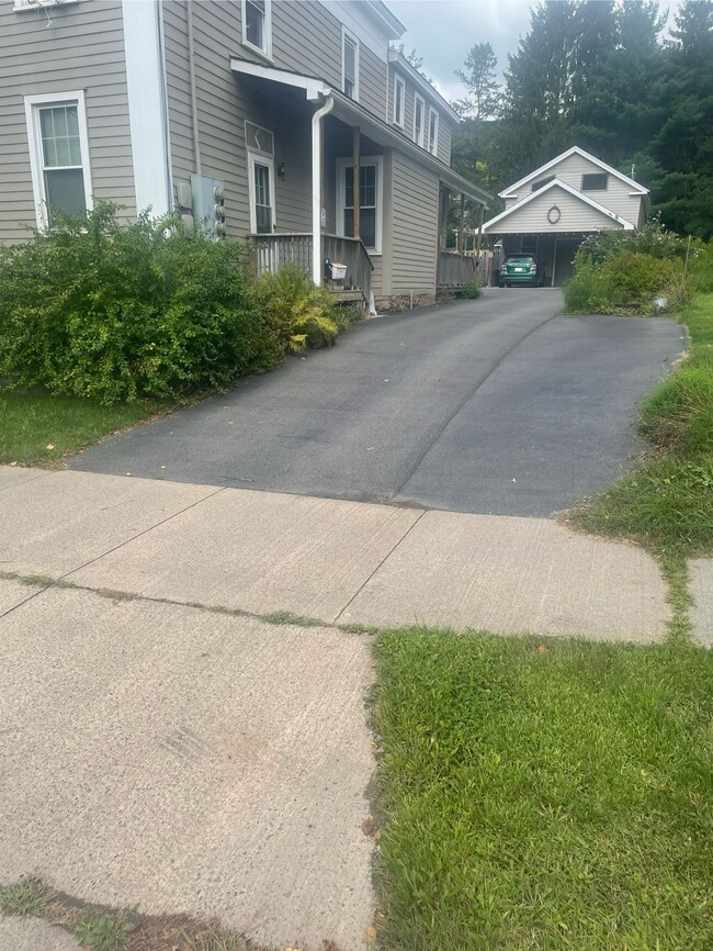 Driveway with one car parking across from entrance - 156 Main St