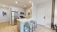 Located at 36 Stony Hill Road in Bethel, CT, this thoughtfully designed single-floor residence offers a smart and functional layout across a comfortable footprint. Light hardwood flooring runs throughout, tying together each room with a clean, cohesive aesthetic.

The open-concept kitchen is outfitted with stainless steel appliances, white shaker cabinetry, and a sleek white quartz peninsula with bar seating — ideal for casual dining or entertaining. The living room makes a bold statement with a striking geometric accent wall in navy and white, large windows that invite natural light, and a neighborhood view that connects the interior to the outside.

The bedroom is a serene retreat featuring a dramatic full-wall art mural, a bright window with outdoor views, and warm wood flooring that complements the natural-toned furnishings. A dedicated office space provides a quiet work area, accented by soft sage-green walls and generous natural light.

The bathroom is finished with striking marble-style tile flooring and wall surround, a soaking tub with brushed gold fixtures, a gray shaker vanity with gold hardware, and elegant lighting — combining luxury and practicality. A hallway and closet round out the layout, ensuring ample storage and ease of circulation throughout this well-crafted Bethel residence.