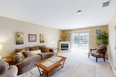 Located at 1600 West Creek Village Drive in Elkton, Maryland, this one-bedroom, one-bathroom residence offers a well-organized, single-floor layout with a warm and inviting ambiance throughout. Neutral beige tones, carpet flooring, and consistent trim work create a cohesive aesthetic across all rooms.

The living room serves as the heart of the home, highlighted by a corner fireplace and a sliding glass door that opens to a private balcony with views of the surrounding community. A pass-through window connects the living area directly to the kitchen, which features wood-toned cabinetry and provides an open, connected feel. The adjacent dining room is a cozy, tile-floored space with a centered overhead pendant light and a window that brings in natural light.

The bedroom is comfortably sized, featuring a ceiling fan, two windows for ample natural light, and closet access. The full bathroom includes a tub/shower combination and tile flooring. A dedicated laundry area with a full-size washer and dryer adds everyday convenience.

A carpeted hallway connects the main living areas to the private spaces, with three closets distributed throughout the unit offering generous storage. The overall layout is efficient and functional, making excellent use of the available floor space.