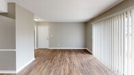Located at 3409 Primm Ln in Hoover, Alabama, this single-story 2-bedroom, 2-bathroom home offers a well-organized layout with a comfortable, neutral aesthetic throughout. The living room features wood-look laminate flooring and a sliding glass door with vertical blinds, allowing natural light to fill the space. The kitchen is a standout, outfitted with gray shaker-style cabinetry, light stone-patterned countertops, a classic subway tile backsplash, a double stainless steel sink, and a full suite of stainless steel appliances including a range, over-the-range microwave, dishwasher, and refrigerator. Wood-look flooring continues seamlessly from the living area into the kitchen. Both bedrooms feature plush carpeting, ceiling fans with light fixtures, and closet storage. The primary bedroom is generously sized with a window providing outdoor views and natural light. The second bedroom offers a quieter, cozier feel with warm neutral walls. Each bathroom is finished with stone-patterned countertops, wood-look flooring, and clean, modern fixtures. A connecting hallway ties the layout together efficiently, making this home functional and easy to navigate.