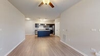 Located at 405 Smith Rd in Saint Charles, IL, this well-appointed 3-bedroom, 2-bathroom single-floor home offers a thoughtfully designed layout with modern finishes throughout. The open-concept kitchen and living area serves as the heart of the home, featuring dark espresso cabinetry, granite-style countertops, stainless steel appliances, a center island, and pendant lighting — all flowing seamlessly onto light wood-look flooring. The adjacent living room is generously sized and bright, with a ceiling fan and a clean, neutral palette that creates a welcoming atmosphere. Each bedroom is carpeted for comfort and includes a ceiling fan and windows that invite natural light, offering pleasant neighborhood views. The primary bedroom includes access to a walk-in closet equipped with wire shelving systems. Both bathrooms are finished with dark vanity cabinetry, granite-style countertops, and a tub-shower combination. Additional highlights include a spacious attached garage with an automatic door opener, two closets for extra storage, and consistent neutral-toned walls throughout that lend a clean, move-in-ready feel. The single-level floor plan ensures easy accessibility and efficient use of space across the entire home.