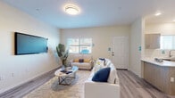 Located at 2000 N 10th St in El Centro, California, this two-story residence combines contemporary design with functional living spaces throughout. The interior features light-toned luxury vinyl plank flooring in the main living areas, creating a cohesive and easy-to-maintain foundation across multiple rooms.

The living room is bright and open, with neutral walls, a flush-mount ceiling light, and a window fitted with blinds that allows natural light to fill the space. The kitchen is well-equipped with light wood-tone cabinetry, white quartz countertops, stainless steel appliances including a gas range, microwave, dishwasher, and refrigerator, along with a window above the sink. An adjacent dining area provides space for a table and chairs, positioned conveniently near the refrigerator.

The bedrooms are carpeted for comfort, each featuring windows with blinds and ample natural light. One bedroom includes a ceiling fan, while another offers generous closet space with built-in shelving. The bathroom features a long vanity with light wood cabinetry, white countertops, and direct access to a walk-in shower area.

Additional highlights include a spacious attached garage with an automatic opener, providing secure parking and extra storage potential.
