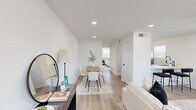 Located at 5911 Sheridan Avenue in Austin's 78723 zip code, this efficiently designed single-story, one-bedroom, one-bathroom unit offers a cohesive modern aesthetic throughout. Light wood-look flooring flows seamlessly across the entire space, complemented by crisp white walls and textured ceilings with recessed lighting and sleek black ceiling fans.

The living room is bright and welcoming, with multiple windows allowing generous natural light and a direct-access entry door, creating an open and airy atmosphere. Adjacent to it is a functional dining nook with bar-height seating, making excellent use of the available space.

The kitchen is laid out in a smart galley configuration, featuring white shaker-style cabinetry, stainless steel appliances — including a refrigerator, gas range, and dishwasher — and a window that brings in additional natural light.

The bedroom is a well-proportioned retreat with two windows offering views of the surrounding neighborhood, a ceiling fan, and access to both a dedicated closet and the hallway. The bathroom is a standout feature, showcasing floor-to-ceiling marble-look tile in the walk-in shower, matte black fixtures including a rain showerhead, and a clean white vanity — delivering a spa-inspired finish in a compact footprint.