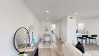 Located at 5911 Sheridan Avenue in Austin's 78723 zip code, this efficiently designed single-story, one-bedroom, one-bathroom unit offers a cohesive modern aesthetic throughout. Light wood-look flooring flows seamlessly across the entire space, complemented by crisp white walls and textured ceilings with recessed lighting and sleek black ceiling fans.

The living room is bright and welcoming, with multiple windows allowing generous natural light and a direct-access entry door, creating an open and airy atmosphere. Adjacent to it is a functional dining nook with bar-height seating, making excellent use of the available space.

The kitchen is laid out in a smart galley configuration, featuring white shaker-style cabinetry, stainless steel appliances — including a refrigerator, gas range, and dishwasher — and a window that brings in additional natural light.

The bedroom is a well-proportioned retreat with two windows offering views of the surrounding neighborhood, a ceiling fan, and access to both a dedicated closet and the hallway. The bathroom is a standout feature, showcasing floor-to-ceiling marble-look tile in the walk-in shower, matte black fixtures including a rain showerhead, and a clean white vanity — delivering a spa-inspired finish in a compact footprint.