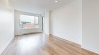 Located at 2855 Ch Bates in Montréal, this well-appointed 2-bedroom, 2-bathroom unit offers a thoughtfully designed single-floor layout with a clean, contemporary aesthetic. Light hardwood flooring runs throughout the living spaces, complementing the bright white walls and recessed lighting that create an airy, modern atmosphere.

The open-concept kitchen and living area serves as the heart of the unit. The kitchen is outfitted with a two-tone cabinet design — crisp white lower cabinetry paired with warm wood-finish upper cabinets — alongside a white quartz island, stainless steel appliances, and a stainless undermount sink. The living area benefits from large windows that invite generous natural light and provide views of the surrounding Montréal neighbourhood, with direct access to a private balcony.

Both bedrooms are well-proportioned, featuring the same light hardwood flooring, large windows with neighbourhood views, and baseboard heating. The primary bedroom offers a comfortable footprint with ample wall space. The two bathrooms are finished in a neutral, contemporary palette; one features a glass-enclosed walk-in shower, while the other includes a bathtub/shower combination, both with wood-toned vanities and light stone-effect tile flooring.
