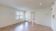 Located at 10801 Heather Ridge Cir in Orlando, FL, this one-bedroom, one-bathroom unit offers a well-planned single-floor layout that maximizes every square foot. The open-concept living and dining area is bright and welcoming, featuring warm wood-look flooring, neutral-toned walls, a textured ceiling, and a ceiling fan with light fixture. Large windows allow abundant natural light to fill the space, while a sliding glass door leads directly to a private patio with pleasant outdoor views of surrounding greenery.

The kitchen is efficiently designed with white cabinetry, stainless steel appliances including a refrigerator, range, and over-the-range microwave, a dishwasher, and a striking quartz peninsula countertop that opens to the living area — ideal for casual dining or entertaining. Wood-look flooring extends throughout.

The bedroom is a comfortable, well-proportioned retreat with wood-look flooring, white walls, and access to a dedicated closet. The full bathroom features a quartz-topped vanity, wood-look flooring, and a tub/shower combination with clean white finishes. A laundry area rounds out the functional offerings of this thoughtfully laid-out Orlando home.