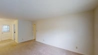 Located at 1201 Columbus Cir in Wilmington, North Carolina, this single-floor residence offers a straightforward and functional layout designed for comfortable everyday living. The interior features neutral-toned walls paired with wall-to-wall carpeting in a warm beige hue, creating a clean and cohesive aesthetic throughout. The rooms are well-proportioned, with standard ceiling heights that contribute to a comfortable sense of space. The minimalist design of the interior provides a blank canvas, allowing future occupants to personalize the space to their liking. Doorways connect the rooms in a practical flow, supporting ease of movement throughout the home. The overall ambiance is simple, bright, and move-in ready, with a neutral palette that complements a wide range of furnishing styles. Situated in Wilmington, NC, the property benefits from its established residential surroundings, offering a quiet and accessible setting for daily life.