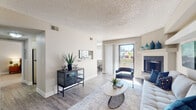 Located at 250 Rim View Dr in Colorado Springs, CO, this single-level residence offers a thoughtfully designed layout with modern updates throughout. The living room serves as the heart of the home, featuring wood-look flooring, a textured ceiling, and a fireplace with a raised mantle shelf. A sliding glass door allows abundant natural light to fill the space while providing direct access to the outdoors. Vaulted ceiling details near the fireplace wall add architectural interest and a sense of openness.

The galley-style kitchen is well-appointed with white cabinetry, stainless steel appliances including a refrigerator, range, and built-in microwave, as well as a marble-look countertop and a stainless steel sink. Wood-look flooring continues through this space, and a pass-through connects it to adjacent areas for ease of use.

The bedroom is a comfortable retreat with plush carpeting, a textured ceiling, and a window that admits natural light. The bathroom features a white vanity with marble-look counters, wood-look flooring, and clean neutral tones. A dedicated in-unit laundry area with side-by-side washer and dryer adds everyday convenience to this well-rounded Colorado Springs residence.
