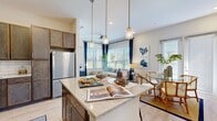 This contemporary apartment showcases an expertly designed open floor plan that seamlessly integrates the kitchen, dining, and living areas. The kitchen is a chef's delight, boasting stainless steel appliances, granite countertops, and ample cabinet space. The living room is bathed in natural light from large windows, complemented by stylish pendant lighting. Comfortable seating and coastal-inspired artwork create a relaxing ambiance.

The bedrooms feature plush carpeting and continue the coastal theme with nautical accents. Large windows offer scenic views, while the bathrooms are appointed with modern fixtures and granite vanities. Throughout the apartment, a cohesive color palette of whites, blues, and natural wood tones enhances the fresh, airy feel.

Additional amenities include a private balcony or patio, perfect for enjoying outdoor views. The apartment's thoughtful design maximizes space and functionality, making it an ideal home for modern living. With its blend of style, comfort, and practicality, this apartment offers a highly desirable living experience.