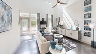 Located at 301 Silveron Blvd in Flower Mound, TX, this two-story, one-bedroom, two-bathroom residence offers a well-designed layout spread across two thoughtfully appointed floors. The main level welcomes you into a dramatic living room boasting soaring ceilings, abundant natural light streaming through tall windows, and direct access to an outdoor balcony. The open-concept kitchen is a standout feature, showcasing rich dark cabinetry, a subway tile backsplash, granite countertops, a center island with bar seating, and a full suite of stainless steel appliances, including a refrigerator, dishwasher, and over-the-range microwave. A half bath on the main level adds everyday convenience. The polished concrete flooring throughout the lower level adds a modern, industrial touch. Upstairs, the generously sized primary bedroom offers plush carpeting, a ceiling fan, multiple windows with views of the surrounding greenery, and ample room to relax. A dedicated closet and a full bathroom with a granite vanity, dark cabinetry, and a tub/shower combination complete the upper level. The overall aesthetic is modern and clean, with crisp white walls providing a neutral backdrop throughout.