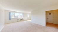 Located at 1641 33rd Street Southwest in Allentown, PA, this single-floor, one-bedroom, one-bathroom residence offers a well-organized and functional layout. The open living and dining area is generously sized, featuring large windows that flood the space with natural light and offer views of the surrounding neighborhood. Soft wall-to-wall carpeting runs throughout the main living spaces, contributing to a warm and comfortable ambiance. The kitchen is a standout feature, showcasing rich cherry wood cabinetry, granite countertops, a double stainless steel sink, and white appliances including a gas range, built-in microwave, and dishwasher, all set on light tile flooring. The spacious primary bedroom includes two windows, wall-to-wall carpeting, a dedicated closet, and direct access to the full bathroom. The bathroom features classic white subway tile surrounding a full soaking tub, complemented by a window for natural ventilation. Three closets throughout the unit provide excellent storage options. A dedicated laundry area adds everyday convenience. The clean, neutral palette and bright interiors create a welcoming and move-in-ready atmosphere throughout the home.