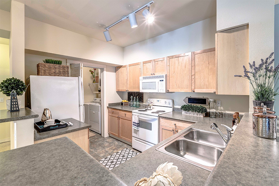 Open kitchens with energy efficient appliances, including dishwasher and mounted microwave - The Lodge at Redmond Ridge