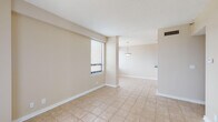 Located at 1550 Jackson Keller Rd in San Antonio, Texas, Unit 1904 is a single-floor residence offering a clean, functional layout with a neutral color palette and light tile flooring throughout. The open living and dining areas are bathed in natural light from large windows fitted with horizontal blinds, creating a bright and welcoming atmosphere. A pendant light fixture anchors the dining space, adding a subtle decorative touch.

The kitchen is well-appointed with dark espresso cabinetry, grey laminate countertops, and a full suite of black appliances including a range, refrigerator, microwave, and dishwasher. Ample cabinet storage lines both sides of the galley-style layout, complemented by a peninsula that connects to the dining area.

The bedroom features a ceiling fan with light kit and a wide window offering expansive views of the surrounding San Antonio landscape. The bathroom includes a soaking tub with tiled surround, a dark-cabinet vanity with a blue-grey countertop, and a large mirror. Tile flooring continues throughout the bathroom for a cohesive finish.

The textured ceilings and consistent warm-toned walls unify the space, while the elevated position of the unit provides notable outdoor views, enhancing the overall living experience.