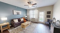 Located at 580 Gipper Way W in Avon, Indiana, this well-appointed 2-bedroom, 2-bathroom single-floor residence offers a thoughtfully designed layout that balances comfort and functionality. The living room is a standout space, featuring rich hardwood-style flooring, a ceiling fan, and a bold slate-blue accent wall that adds character and warmth. Natural light fills the room through a large window and glass exterior door, which opens to outdoor views of the surrounding neighborhood. The combined dining room and kitchen area is equipped with warm cherry wood cabinetry, granite countertops, stainless steel appliances, and a built-in desk nook — ideal for everyday convenience. Both bathrooms continue the granite and cherry wood theme, with the full bath offering a tub/shower combination with brushed nickel fixtures. The spacious primary bedroom features plush carpeting and ample room to furnish comfortably, while the second bedroom also offers carpet flooring and a generous window with neighborhood views. Multiple closets throughout provide excellent storage. A dedicated in-unit laundry room with a full-size washer and dryer adds practical convenience. The overall design blends neutral tones with warm accents, creating an inviting and functional living environment.