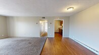 Located at 1336 Camp Hill Way in West Carrollton, Ohio, this single-floor unit offers a well-organized layout designed for comfortable everyday living. The open living area features a combination of plush carpeting and hardwood-style flooring, creating a warm and inviting atmosphere. Large sliding glass doors lead to a private balcony, flooding the space with natural light and offering pleasant views of the surrounding trees and landscape.

The galley-style kitchen is efficiently laid out with warm wood cabinetry, granite-look countertops, a double sink, and a full suite of black appliances including a refrigerator, electric range, microwave, and dishwasher — providing everything needed for home cooking.

The bedrooms are carpeted for comfort, with windows that bring in natural light and views of the outdoors. Each room is served by baseboard heating units. The full bathroom includes a single-sink vanity with wood cabinetry, a tub/shower combo, and hardwood-style flooring, finished in neutral tones throughout.

Additional utility space houses the water heater and offers built-in shelving for storage. The textured ceilings and neutral wall palette throughout create a clean, move-in-ready environment suited for a variety of living arrangements.