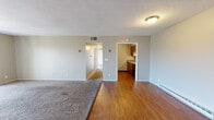 Located at 1336 Camp Hill Way in West Carrollton, Ohio, this single-floor unit offers a well-organized layout designed for comfortable everyday living. The open living area features a combination of plush carpeting and hardwood-style flooring, creating a warm and inviting atmosphere. Large sliding glass doors lead to a private balcony, flooding the space with natural light and offering pleasant views of the surrounding trees and landscape.

The galley-style kitchen is efficiently laid out with warm wood cabinetry, granite-look countertops, a double sink, and a full suite of black appliances including a refrigerator, electric range, microwave, and dishwasher — providing everything needed for home cooking.

The bedrooms are carpeted for comfort, with windows that bring in natural light and views of the outdoors. Each room is served by baseboard heating units. The full bathroom includes a single-sink vanity with wood cabinetry, a tub/shower combo, and hardwood-style flooring, finished in neutral tones throughout.

Additional utility space houses the water heater and offers built-in shelving for storage. The textured ceilings and neutral wall palette throughout create a clean, move-in-ready environment suited for a variety of living arrangements.