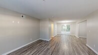 Located at 276 Upper Riverdale Rd in Jonesboro, GA, this single-floor, 2-bedroom, 1-bathroom home offers a clean, modern aesthetic throughout. The open living area is anchored by durable wood-look flooring in a rich gray tone and features a sliding glass door that fills the space with natural light and provides outdoor views. Neutral-toned walls and white trim create a bright, cohesive backdrop throughout.

The kitchen is a standout feature, boasting white shaker-style cabinetry, granite countertops, stainless steel appliances — including a refrigerator, range, and dishwasher — and a double-basin sink, all tied together with matching wood-look flooring.

The spacious primary bedroom offers plush carpeting, a ceiling fan with light fixture, and a closet, providing a comfortable and functional retreat. The second bedroom mirrors this layout with carpet flooring, a ceiling fan, and a window that brings in ample natural light. An additional room features hardwood-style flooring and a window overlooking the outdoors.

The full bathroom is finished with white subway tile surrounding a tub-shower combination, complemented by brushed nickel hardware. Two hallways connect the rooms efficiently, completing this well-laid-out and thoughtfully updated home.